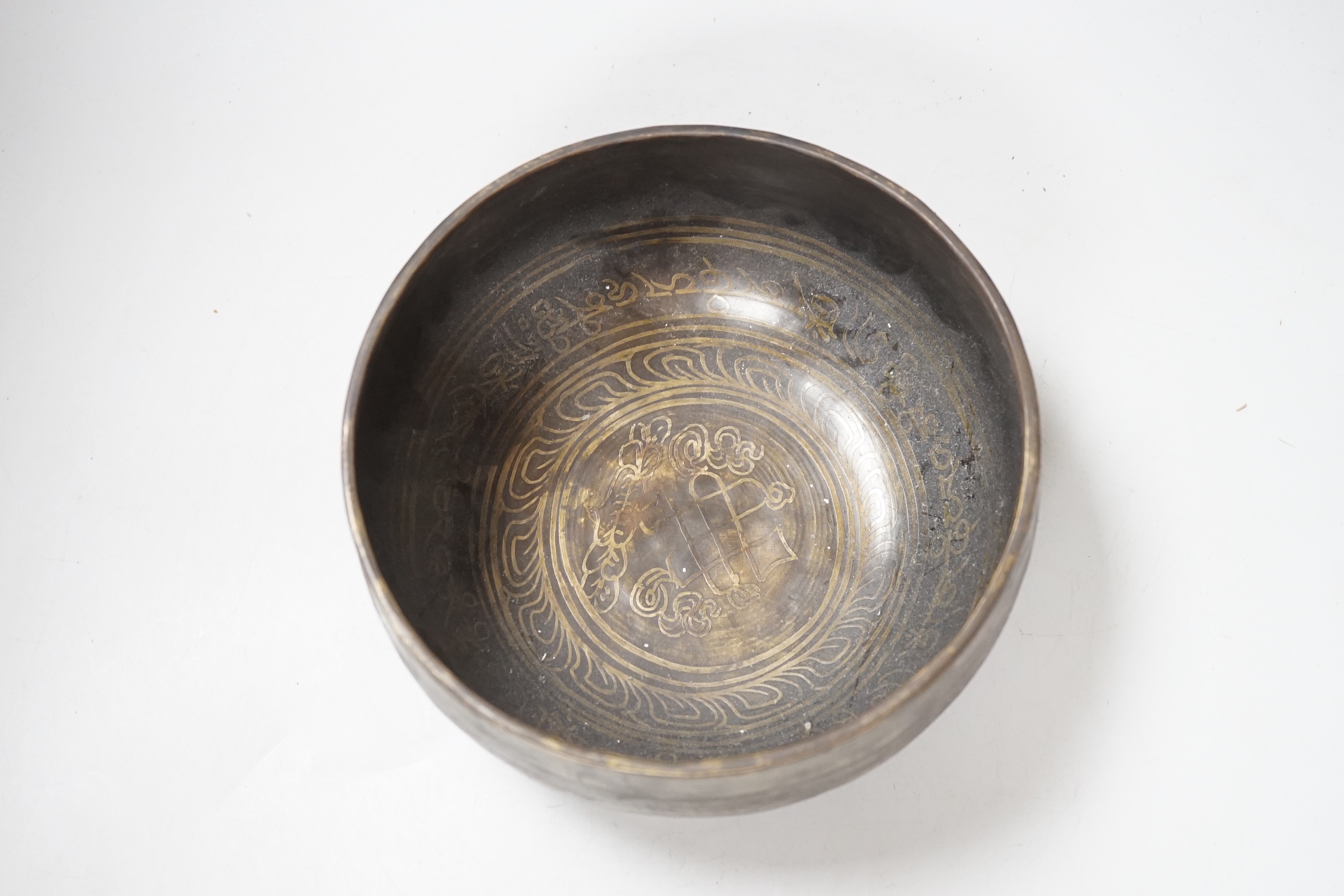 A Tibetan singing bowl with Sanskrit inscription, 19cm diameter